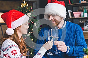 Couple clinking champagne glasses on christmas