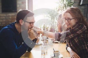 Happy couple flirting and dating in restaurant