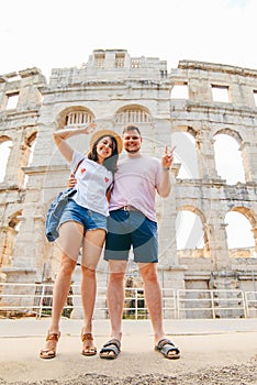 happy beautiful couple in front of coliseum in Pula Croatia