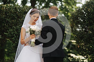 Happy beautiful couple walking in the park in their wedding day. Just married