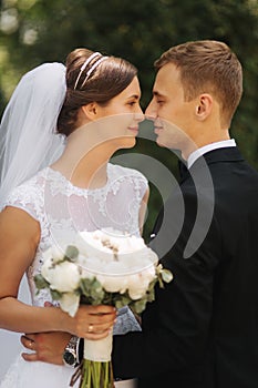 Happy beautiful couple walking in the park in their wedding day. Just married