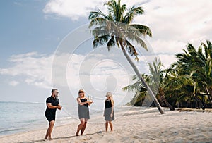 Happy beautiful family on a tropical beach celebrates the birth of their daughter.Family celebrates birthday on the