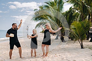 Happy beautiful family on a tropical beach celebrates the birth of their daughter.Family celebrates birthday on the