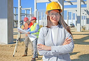 Happy beautiful female architect on construction site