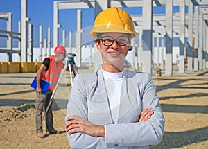 Happy beautiful female architect on a construction site