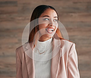 Happy, beautiful and female with her tongue out by a wall with a positive, goofy and confident mindset. Happiness, comic