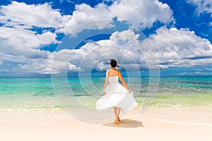 Happy beautiful fiancee in white wedding dress on shore sea. Wed