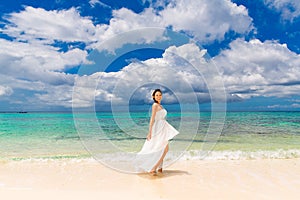 Happy beautiful fiancee in white wedding dress on shore sea. Wed