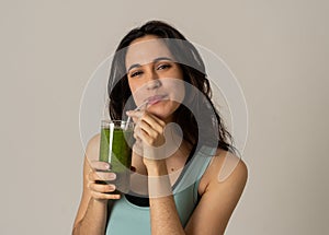 Happy beautiful fit sport woman smiling and drinking healthy fresh vegetable detox smoothie