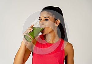 Happy beautiful fit sport woman smiling and drinking healthy fresh vegetable smoothie