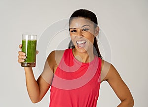 Happy beautiful fit sport woman smiling and drinking healthy fresh vegetable smoothie