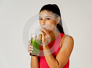 Happy beautiful fit sport woman smiling and drinking healthy fresh vegetable smoothie