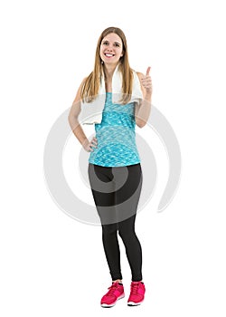 Happy beautiful fitness woman showing thumbs up