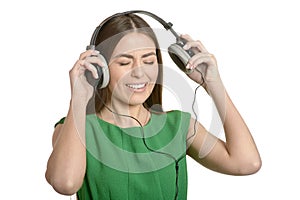 Happy beautiful girl listening to music in headphones isolated