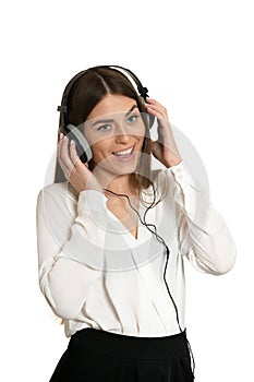 Happy beautiful girl listening to music in headphones isolated