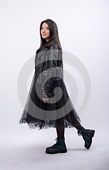 Happy beautiful girl model in black dress posing in studio isolated on white background,Teen girl in black tulle skirt , Full