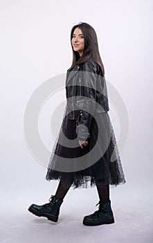 Happy beautiful girl model in black dress posing in studio isolated on white background,Teen girl in black tulle skirt , Full