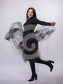 Happy beautiful girl model in black dress posing in studio isolated on white background,Teen girl in black tulle skirt , Full