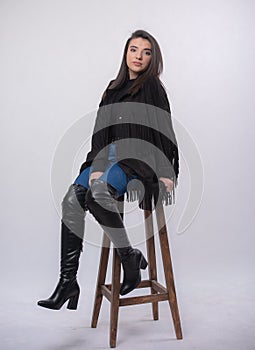 Happy beautiful girl model in black dress posing in studio isolated on white background,Teen girl in in blue jeans and black boots