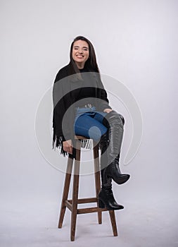Happy beautiful girl model in black dress posing in studio isolated on white background,Teen girl in in blue jeans and black boots