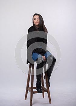 Happy beautiful girl model in black dress posing in studio isolated on white background,Teen girl in in blue jeans and black boots