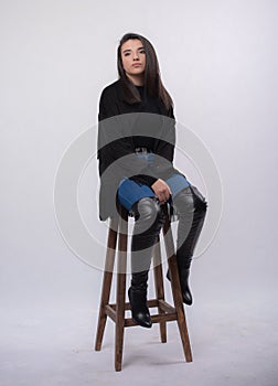 Happy beautiful girl model in black dress posing in studio isolated on white background,Teen girl in in blue jeans and black boots