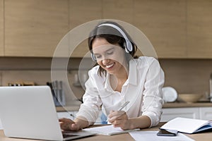 Happy beautiful lady enjoys remote learning on computer