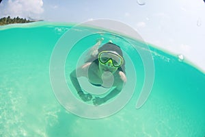 Happy beautiful lady woman swimmer in the ocean diving