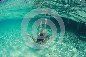 Happy beautiful lady woman swimmer in the ocean diving