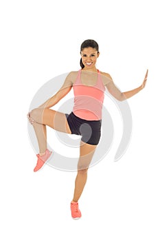 Happy beautiful latin woman stretching body muscles doing fitness workout