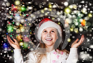 Happy beautiful little girl looks at the sky in the Christmas