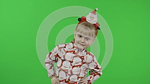 Happy beautiful little girl in a shirt with a Santa Claus. Christmas. Chroma Key