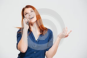 Happy beautiful redhead young woman talking on mobile phone