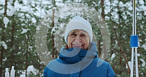 A happy, beautiful retired woman who smiles and looks at the camera