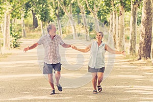 Happy senior couple walking and enjoying life outdoors