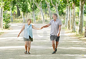 Happy senior couple walking and enjoying life outdoors