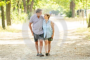 Happy senior couple walking and enjoying life outdoors