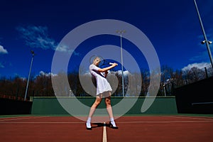 Happy beautiful sexy girl playing tennis on the court. Sport and recreation, leisure
