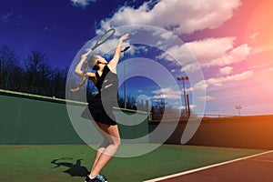 Happy beautiful sexy girl playing tennis on the court. Sport and recreation, leisure