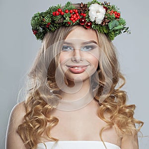 Happy beautiful stylish lady with makeup, long shiny wavy hairdo on white background. Christmas woman portrait