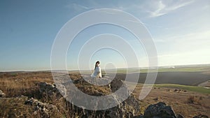 Happy beautiful wedding couple bride and groom at wedding day outdoors on the mountains rock