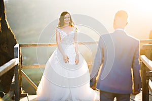 Happy beautiful wedding couple bride and groom at wedding day outdoors on the mountains rock. Happy marriage couple