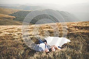 Happy beautiful wedding couple bride and groom at wedding day outdoors on the mountains rock. Happy marriage couple