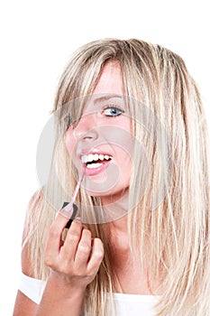 Happy beautiful woman applying lipstick