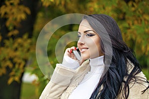 Happy beautiful woman calling by phone