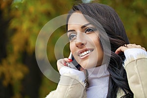 Happy beautiful woman calling by phone