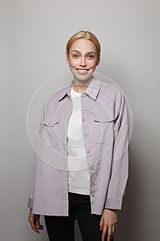 Happy beautiful woman in casual clothes smiling at camera on white studio background