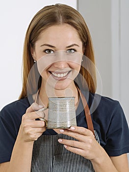 Happy beautiful woman drinking coffee