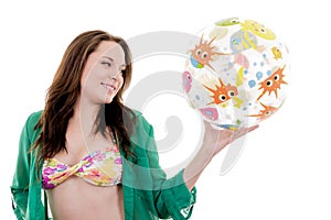 Happy beautiful woman holding a beach ball, white