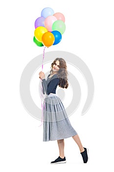 Happy beautiful woman holding colorful balloons isolated on whit